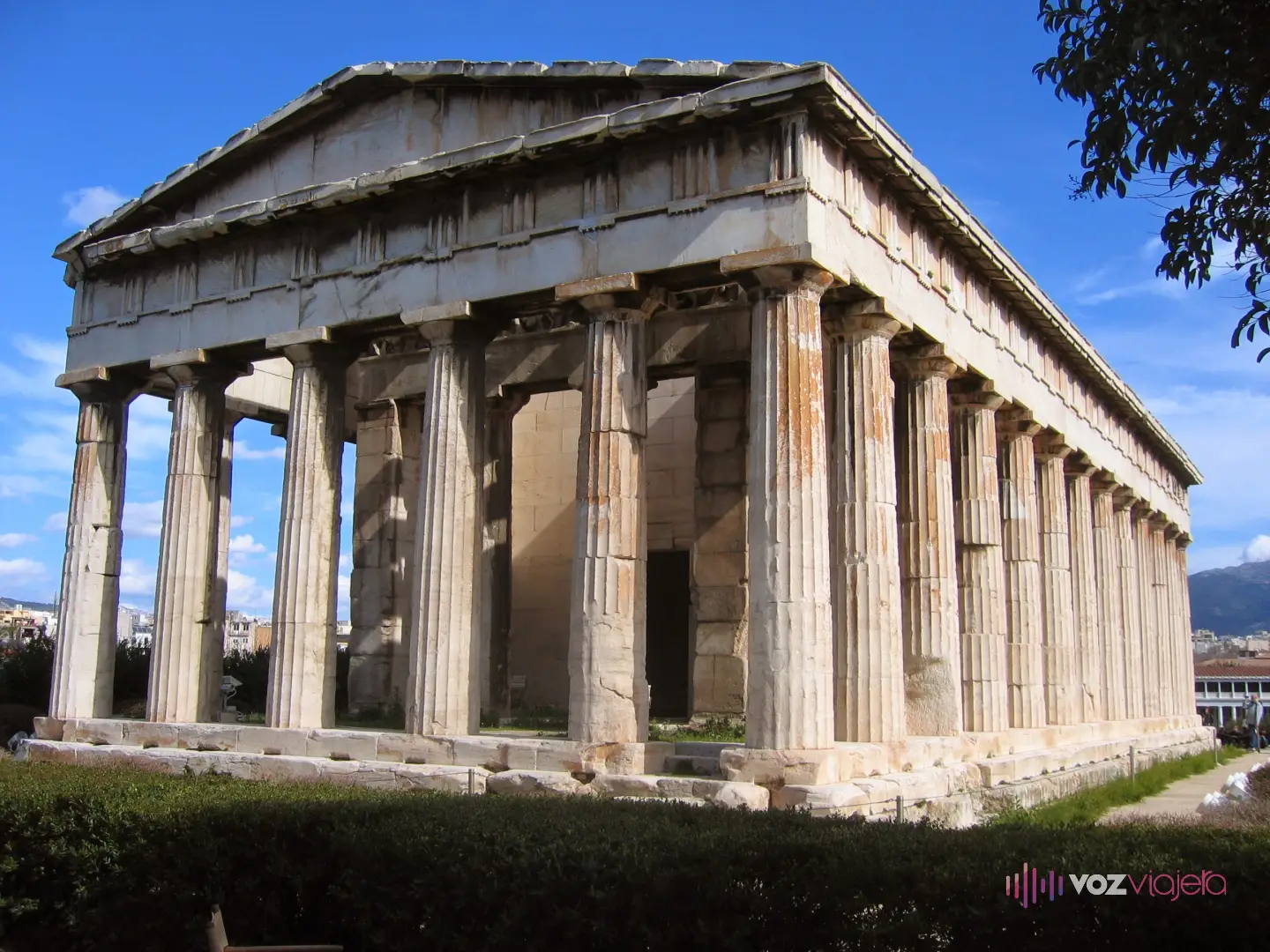 El Templo de Hefesto de Atenas visto desde una esquina, con las columnas dóricas de la fachada y del costado, el friso esculpido y la cubierta todavía en su sitio