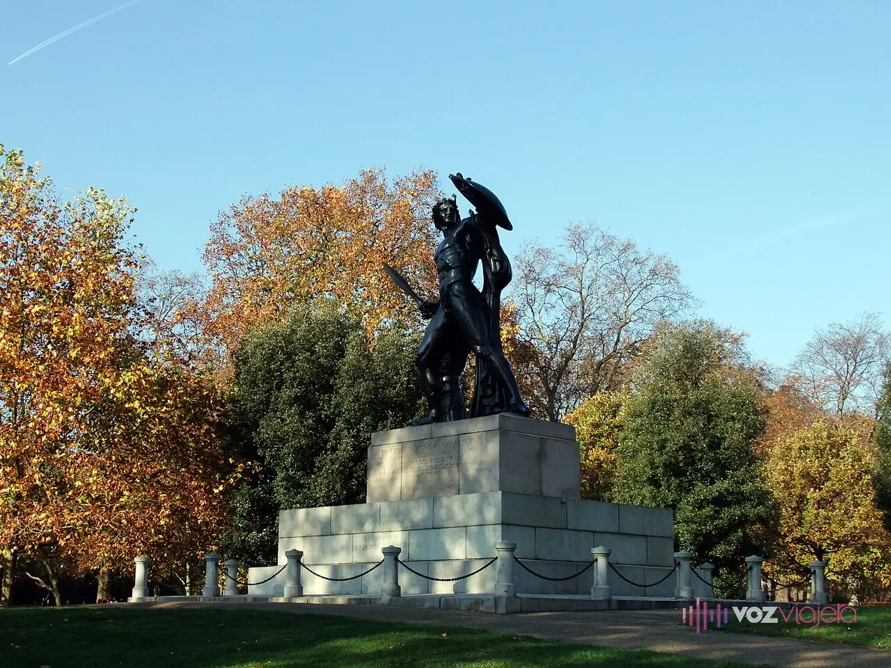 La estatua de bronce de Aquiles con escudo y espada sobre un gran pedestal de granito, entre árboles de otoño, junto a Hyde Park Corner